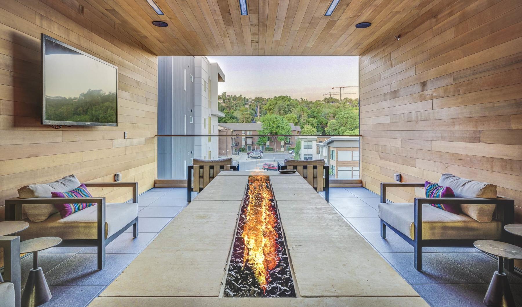 a room with a fire pit down the middle