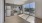 a kitchen with a large glass door to private balcony